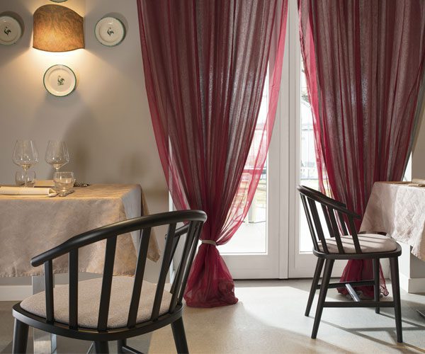 A dining room with two chairs and a table