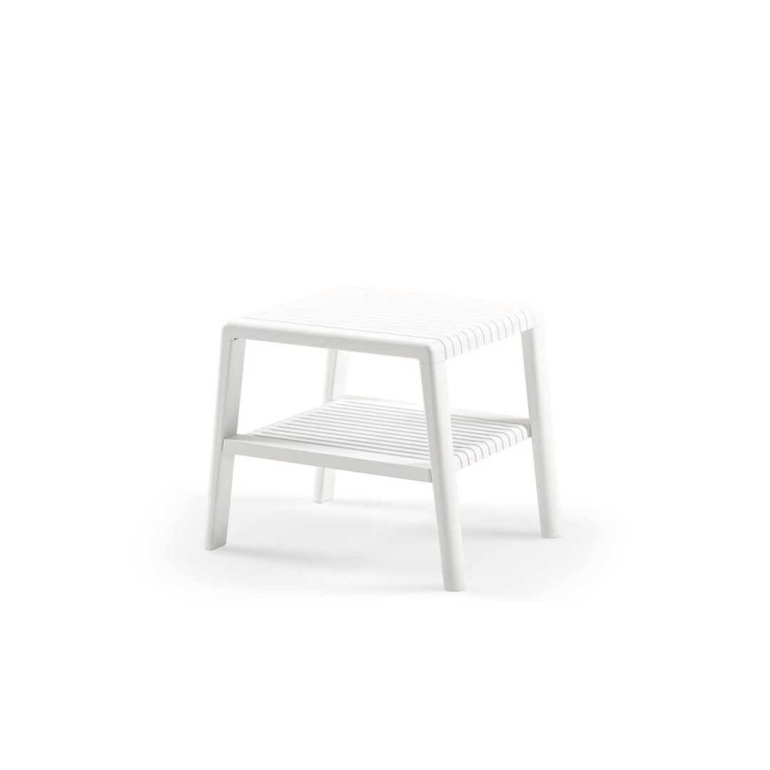 Side view of Joker ivory white commercial outdoor side table with slatted top and lower shelf on angled four-leg frame on white background for outdoor hospitality and resort lounge environments.